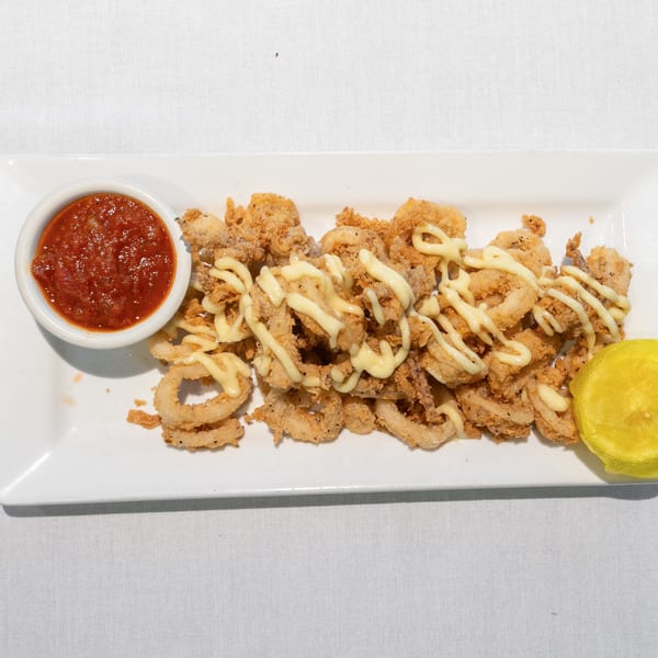 Crispy fried calamari drizzled with aioli, served with marinara sauce and a lemon wedge.